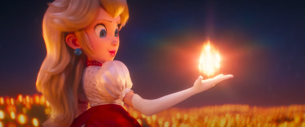 A Fire Flower powered-up Peach stares at the fireball in her hand via The Super Mario Bros. Movie (2023), Illumination, Nintendo