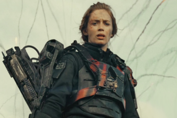 The Angel of Verdun (Emily Blunt) looks on as Major William Cage (Tom Cruise) embarrasses himself on the battlefield in Edge of Tomorrow (2014), Warner Bros. Pictures via Blu-ray