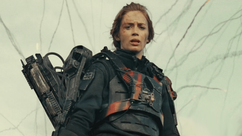 The Angel of Verdun (Emily Blunt) looks on as Major William Cage (Tom Cruise) embarrasses himself on the battlefield in Edge of Tomorrow (2014), Warner Bros. Pictures via Blu-ray