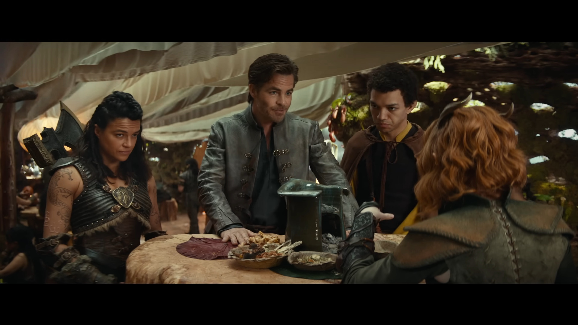 Edgin the Bard (Chris Pine) attempts to reassure Holga the Barbarian (Michelle Rodriguez), Simon the Sorcerer (Justice Smith), and Doric the Druid (Sophia Lillis) of his leadership skills in Dungeons & Dragons: Honor Among Thieves (2023), Paramount Pictures via YouTube