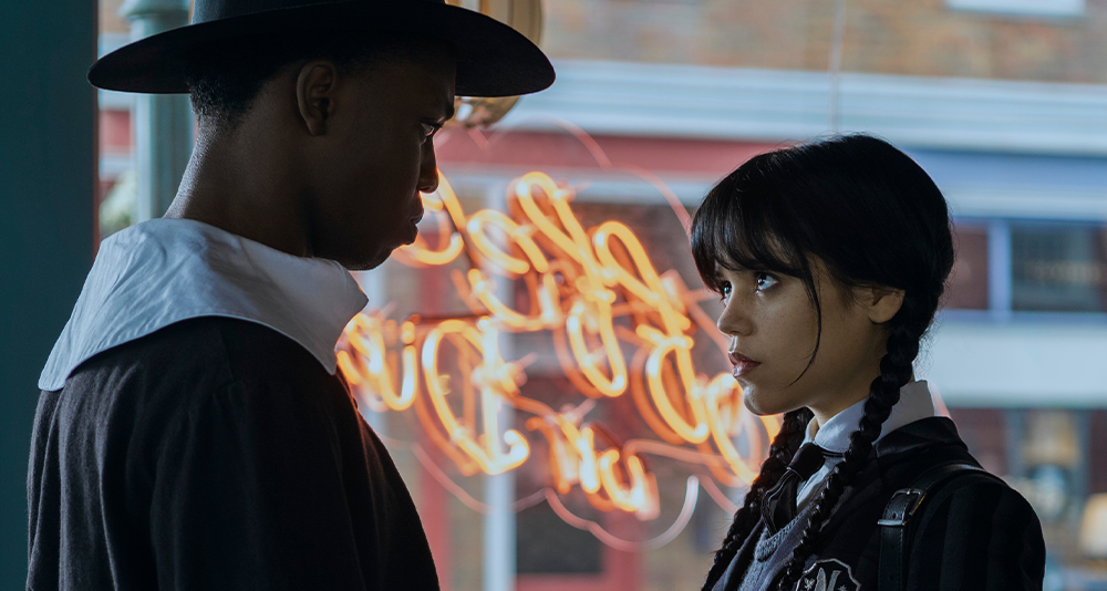 Wednesday. (L to R) Iman Marson as Lucas Walker, Jenna Ortega as Wednesday Addams in episode 101 of Wednesday. Cr. Vlad Cioplea/Netflix © 2022