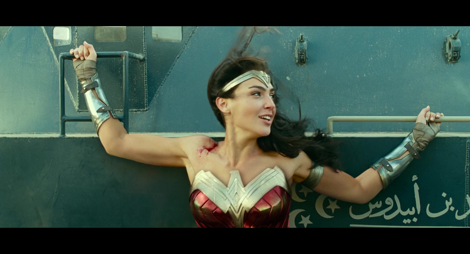 Diana (Gal Gadot) puts herself in between two armored vehicles in Wonder Woman 1984 (2020), Warner Bros. Pictures via Blu-ray
