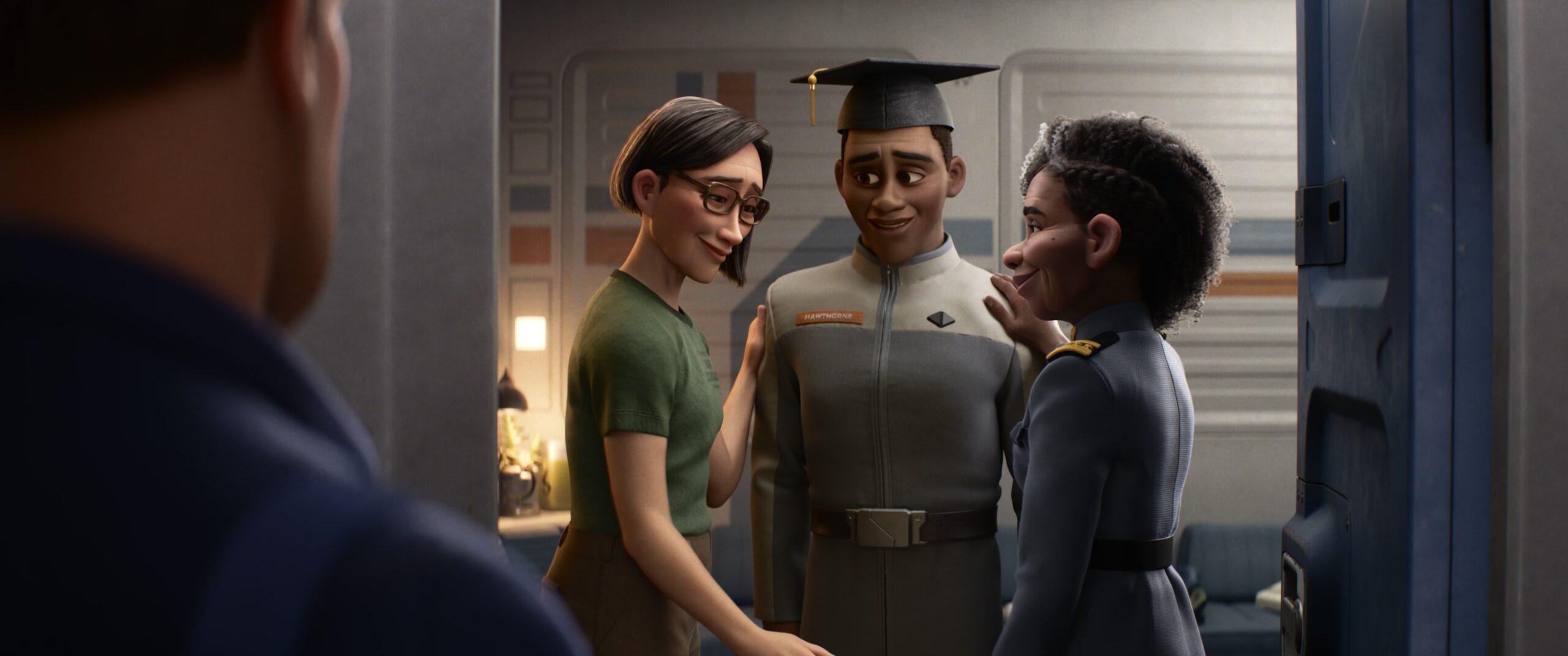 Buzz (Chris Evans) watches Alisha Hawthorne (Uzo Aduba) and his wife, Kiko, attend their son's college graduation in Lightyear, Pixar Animation Studios (2022) via YouTube