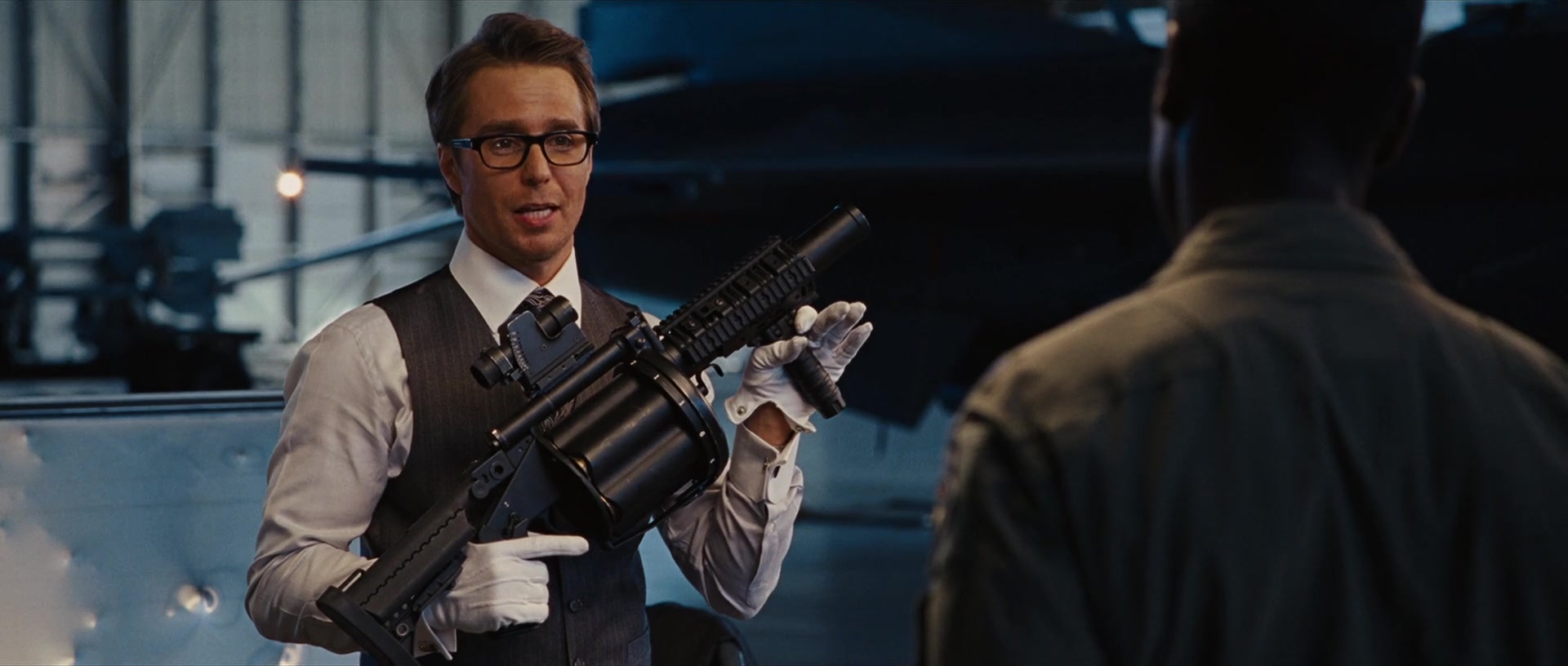 Justin Hammer (Sam Rockwell) proposes adding a Milkor MGL MK 1L to the War Machine armor in Iron Man 2 (2010), Marvel Entertainment via Blu-ray