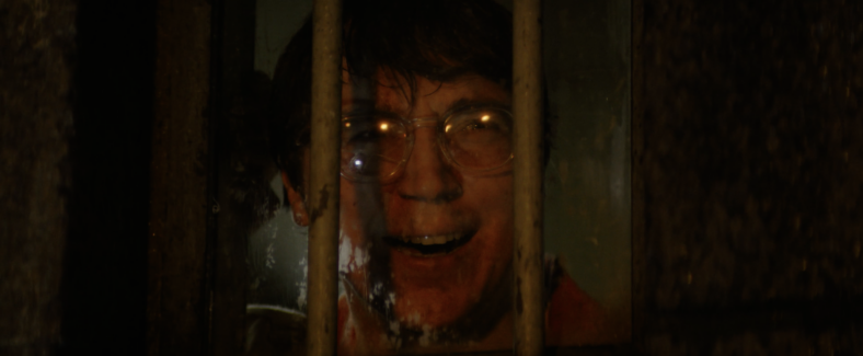 The Riddler (Paul Dano) watches as his plan unfolds in The Batman (2022) via Warner Bros. Pictures