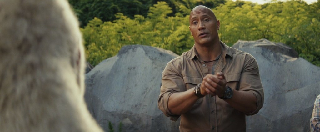 Primatologist and former US Army Special Forces soldier Davis Okoye (Dwayne Johnson) thanks albino gorilla George for saving Connor (Jack Quaid) in Rampage (2018), Warner Bros. Pictures