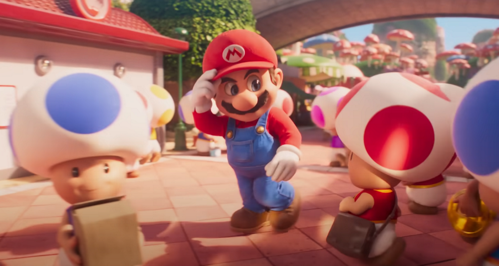 Mario tips his hat to a polite, yet surprised, Toad amid the crowded Toad Town via The Super Mario Bros. Movie (2023), Illumination, Nintendo