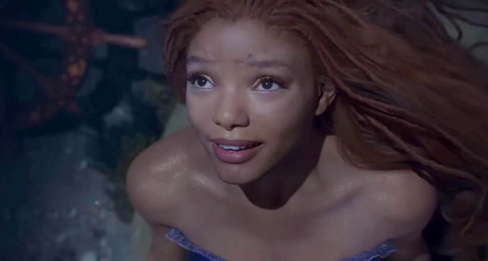 Ariel (Halle Bailey) longs for the surface world in The Little Mermaid (2023), Disney