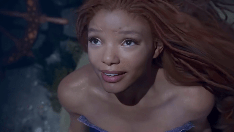 Ariel (Halle Bailey) longs for the surface world in The Little Mermaid (2023), Disney