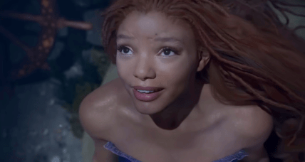 Ariel (Halle Bailey) longs for the surface world in The Little Mermaid (2023), Disney