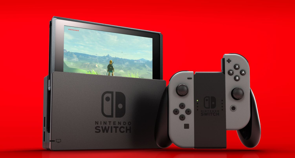 A Nintendo Switch with grey Joy-Cons on a red background. The Legend of Zelda: Breath of the Wild can be seen on the screen via Nintendo