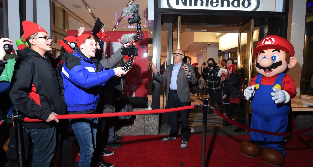 Nintendo of America President Doug Bowser at the Nintendo NY Store Nintendo Switch Launch Event in 2017 alongside Mario and eagerly-awaiting fans via Nintendo