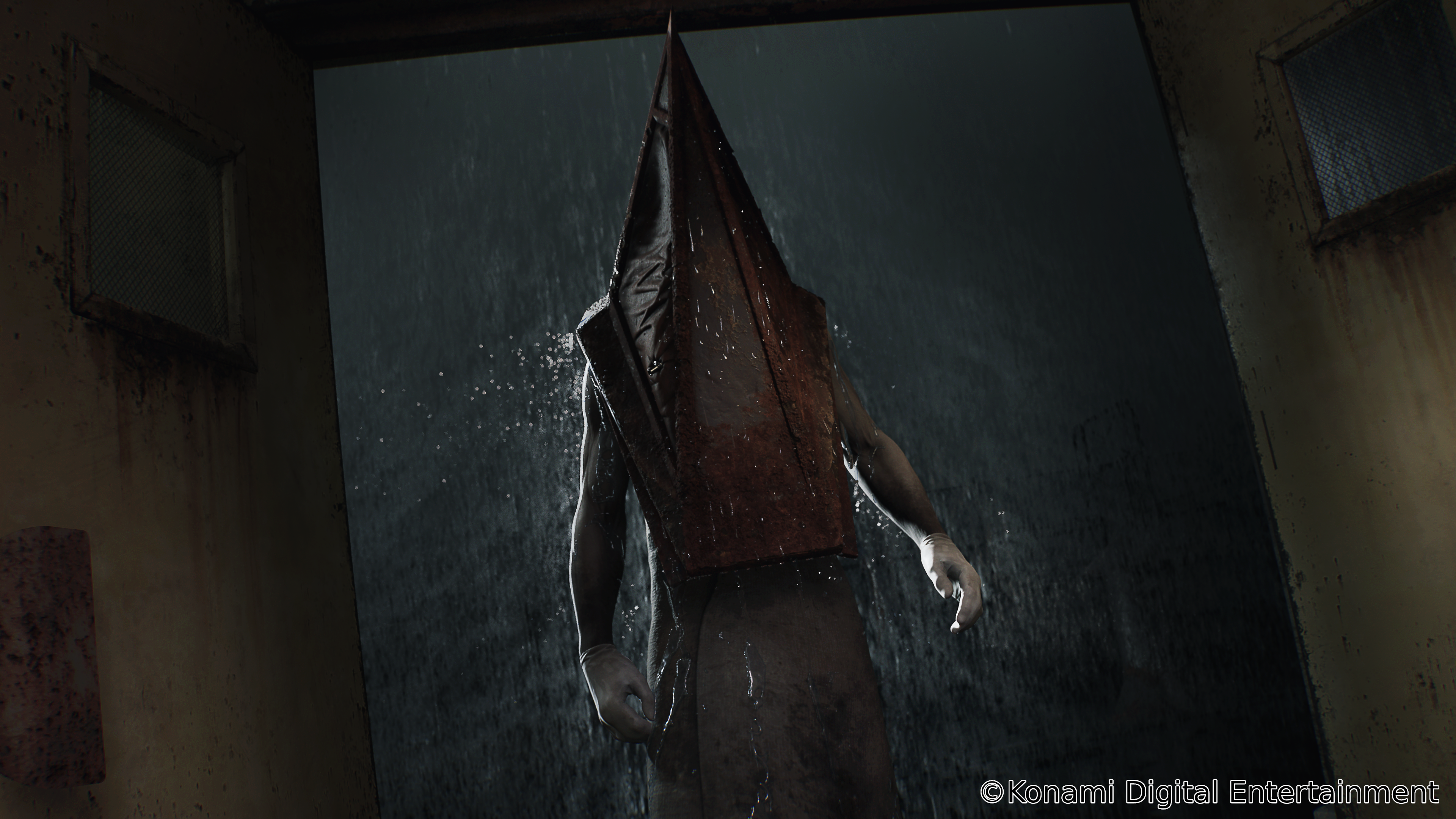 Pyramid Head stands in the doorway, as a downpour showers it via Silent Hill 2 (TBA), Konami