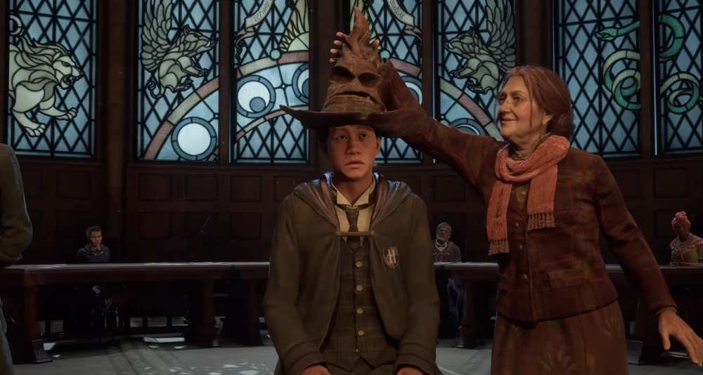 Deputy Headmistress Professor Matilda Weasley places the Sorting Hat on the player character's head via Hogwarts Legacy (2022), Warner Bros. Interactive Entertainment
