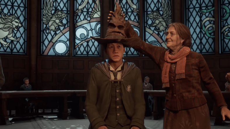 Deputy Headmistress Professor Matilda Weasley places the Sorting Hat on the player character's head via Hogwarts Legacy (2022), Warner Bros. Interactive Entertainment