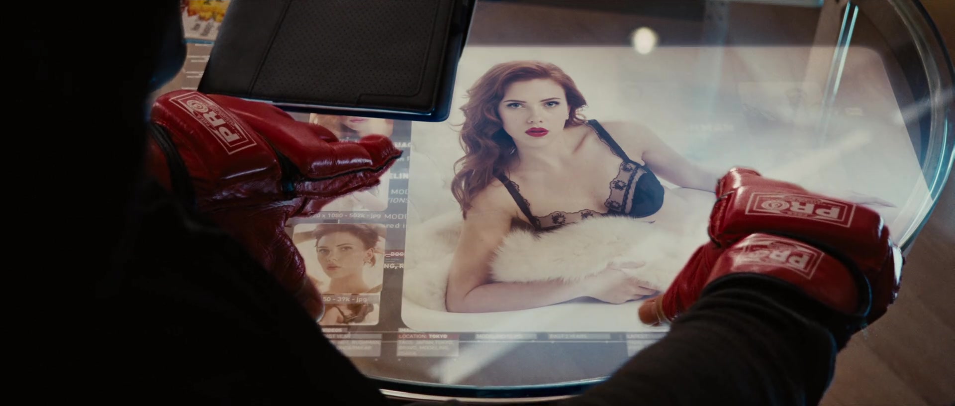 Tony Stark (Robert Downey Jr.) looks into Natasha Romanoff (Scarlet Johansson) in Iron Man 2 (2010), Marvel Studios