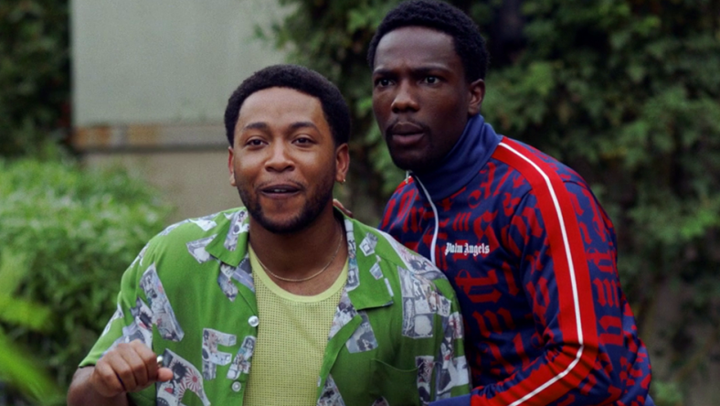 Kevin (Jacob Latimore) and Damon (Tosin Cole) are surprised by a visitor in House Party (2023), Warner Bros. Pictures