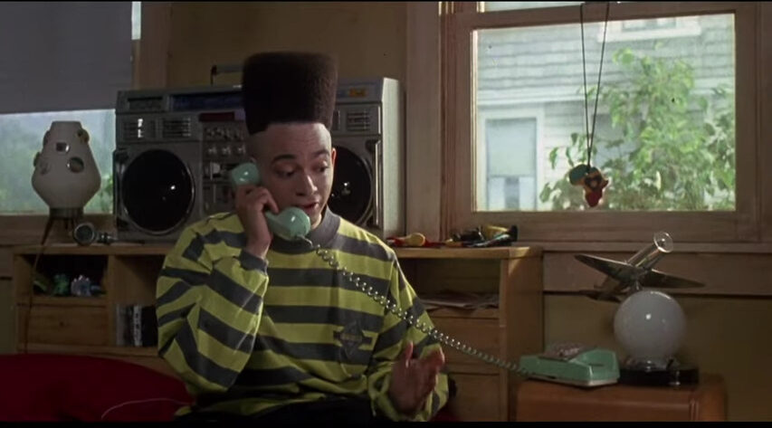 Kid (Christopher Robinson) makes a call in House Party (1990), New Line Cinema