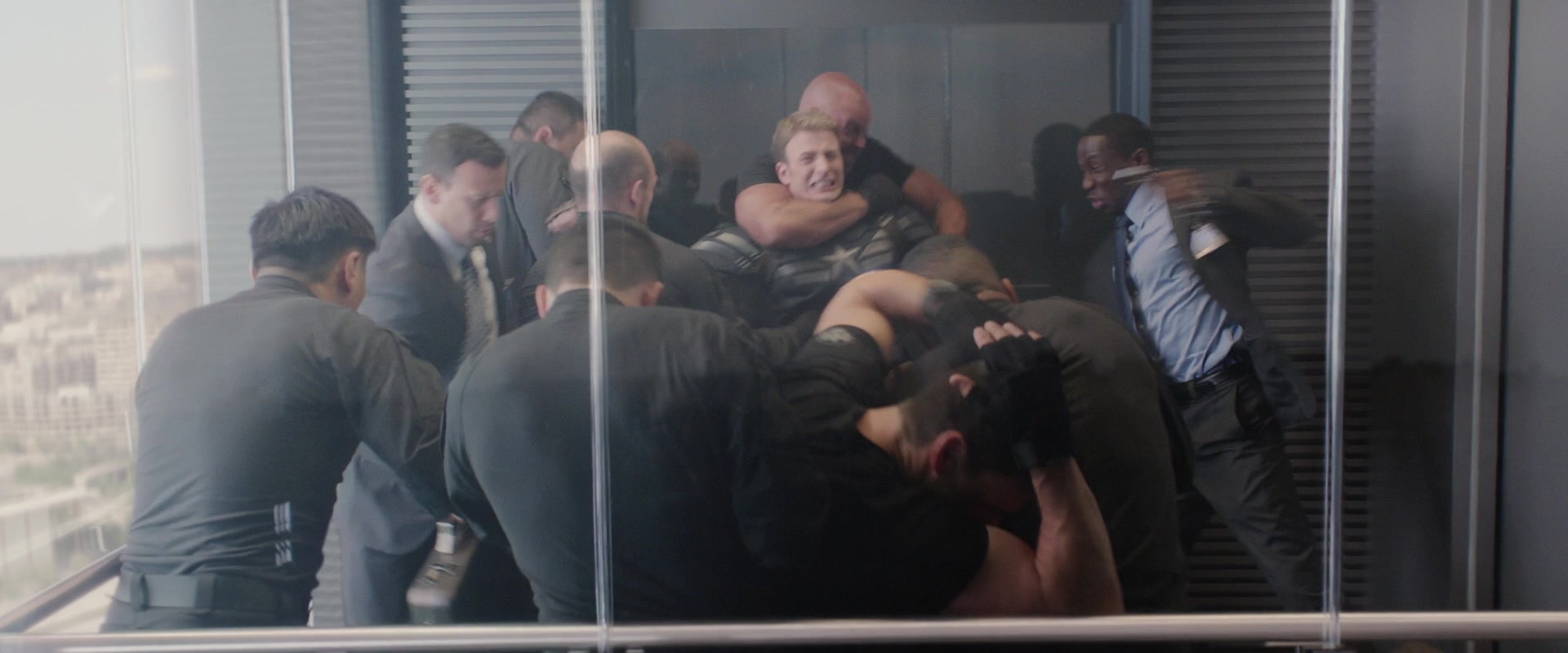 Steve Rogers (Chris Evans) is accosted by Hydra's sleeper agents within S.H.I.E.L.D. in Captain America: The Winter Soldier (2014), Marvel Entertainment