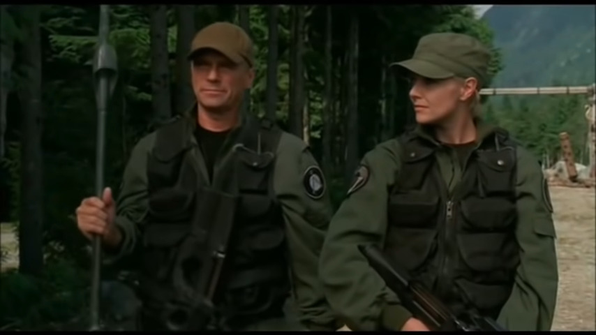 Col. Jack O'Neill (Richard Dean Anderson) and Major Samantha Carter (Amanda Tapping) demonstrate the superiority of an FN P90 compared to a Ma'Tok staff in Stargate SG-1 Season 5 Episode 18 "The Warrior" (2002), MGM