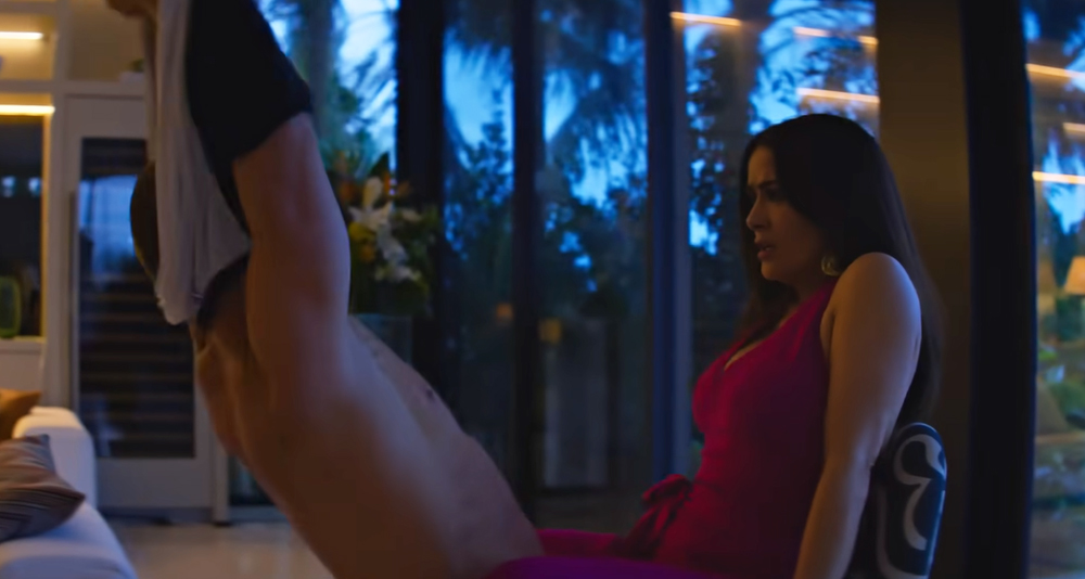 Salma Hayek with her legs spread around Channing Tatum in the movie 'Magic Mike's Last Dance' (2023).