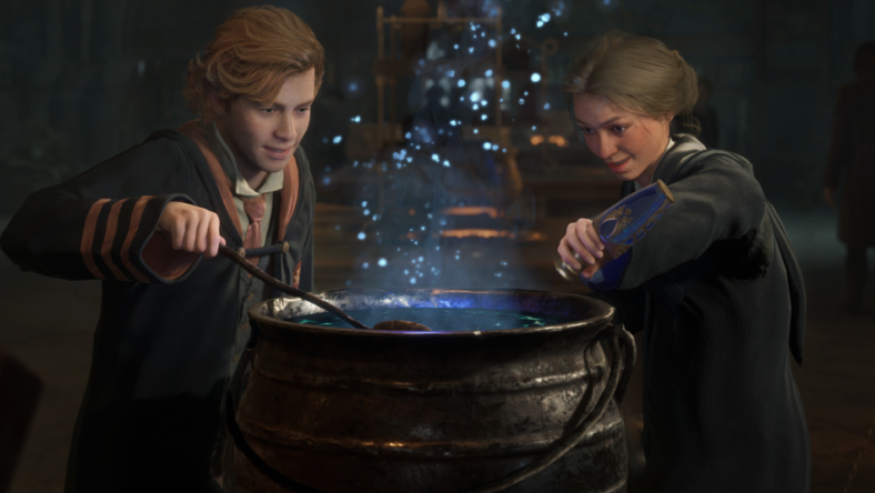 A Griffindor and Ravenclaw student brew a potion in a cauldron, as blue sparks float up from it via Hogwarts Legacy (2023), Warner Bros. Interactive Entertainment