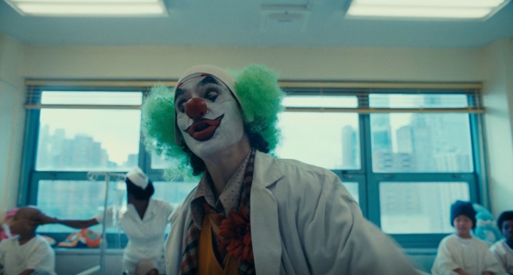 Arthur Fleck (Joaquin Phoenix) entertains hospital patients in Joker (2019), Warner Bros. Entertainment