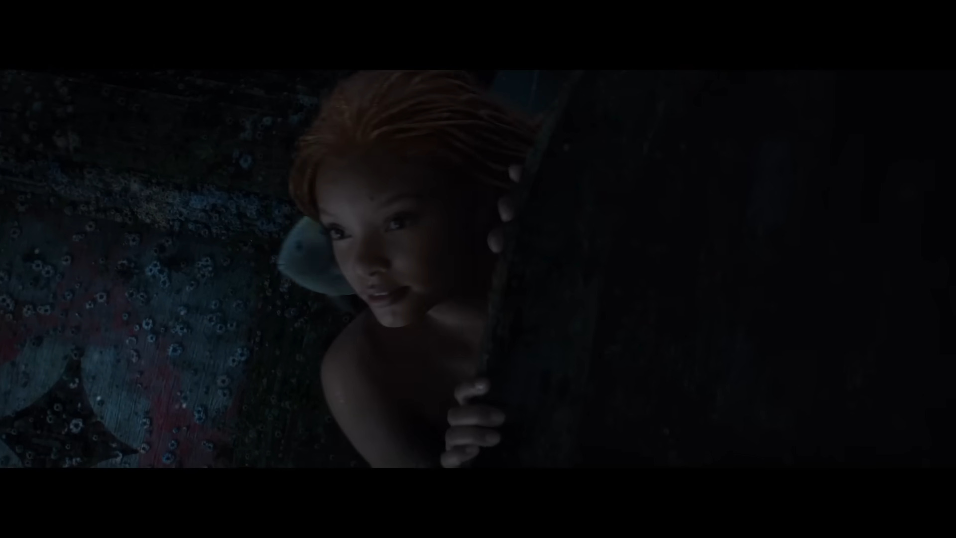 Ariel (Halle Bailey) investigates a shipwreck in The Little Mermaid (2023), Disney