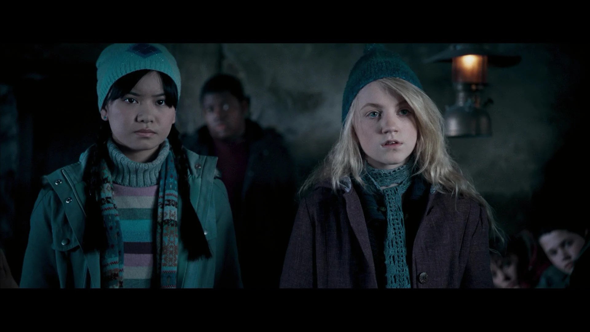 Cho Chang (Katie Leung) and Luna Lovegood (Evanna Lynch) discuss their plans with Harry Potter (Daniel Radcliffe) at the Hog's Head Inn in Harry Potter and the Order of the Phoenix (2007), Warner Bros. Pictures