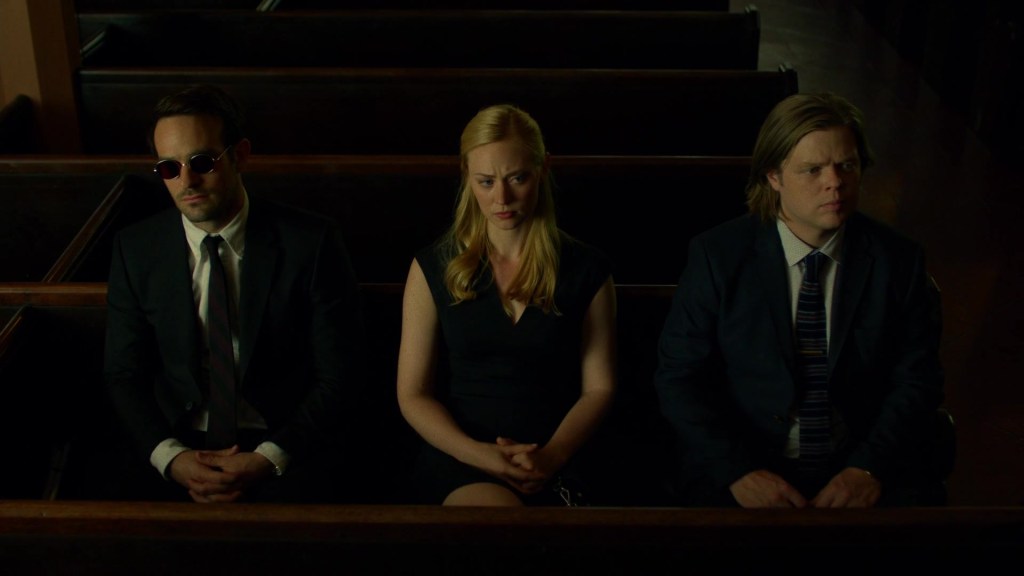 Matt Murdock (Charlie Cox), Karen Page (Deborah Ann Woll) and Foggy Nelson (Elden Henson) attend the funeral of Elliot Grote (McCaleb Burnett) in Daredevil Season 2 Episode 4 "Penny and Dime" (2016), Netflix