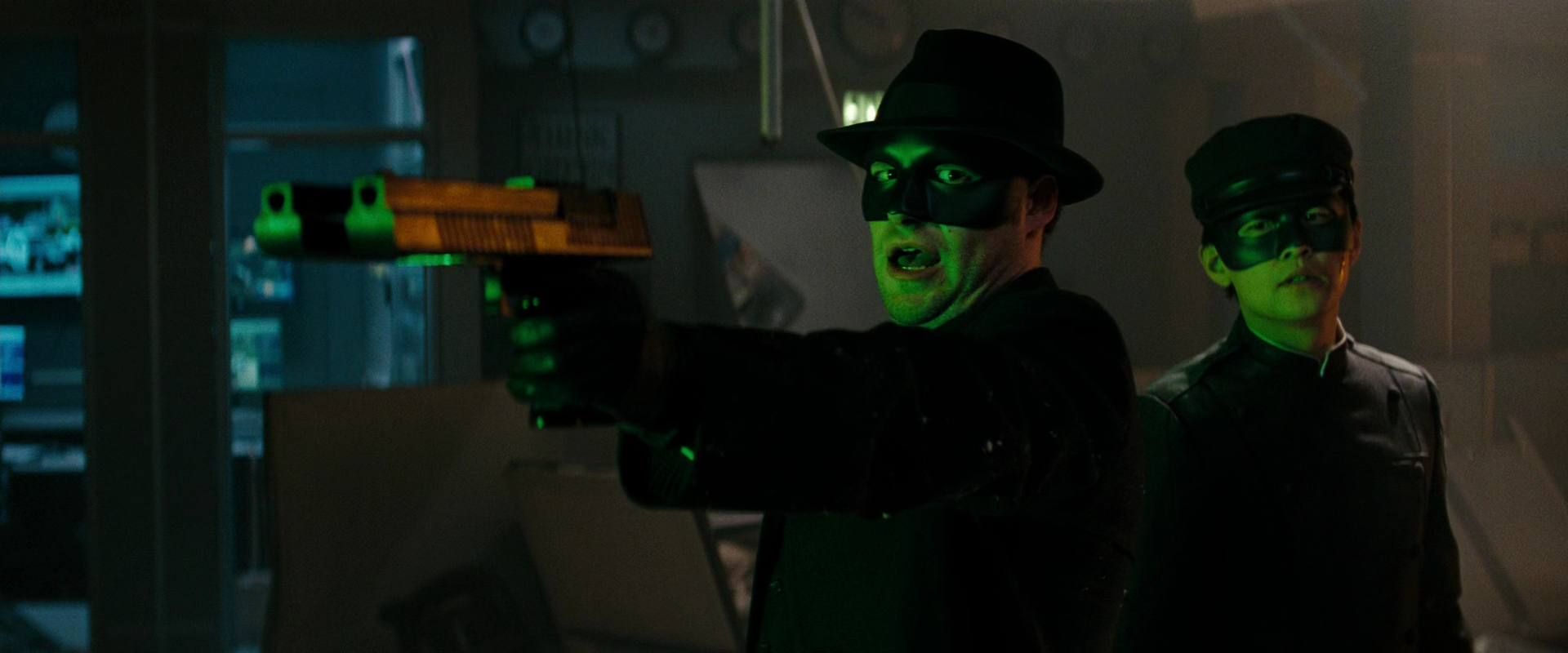 The Green Hornet (Seth Rogen) and Kato (Jay Chou) draw on Benjamin Chudnofsky (Christoph Waltz) in The Green Hornet (2011), Sony Pictures
