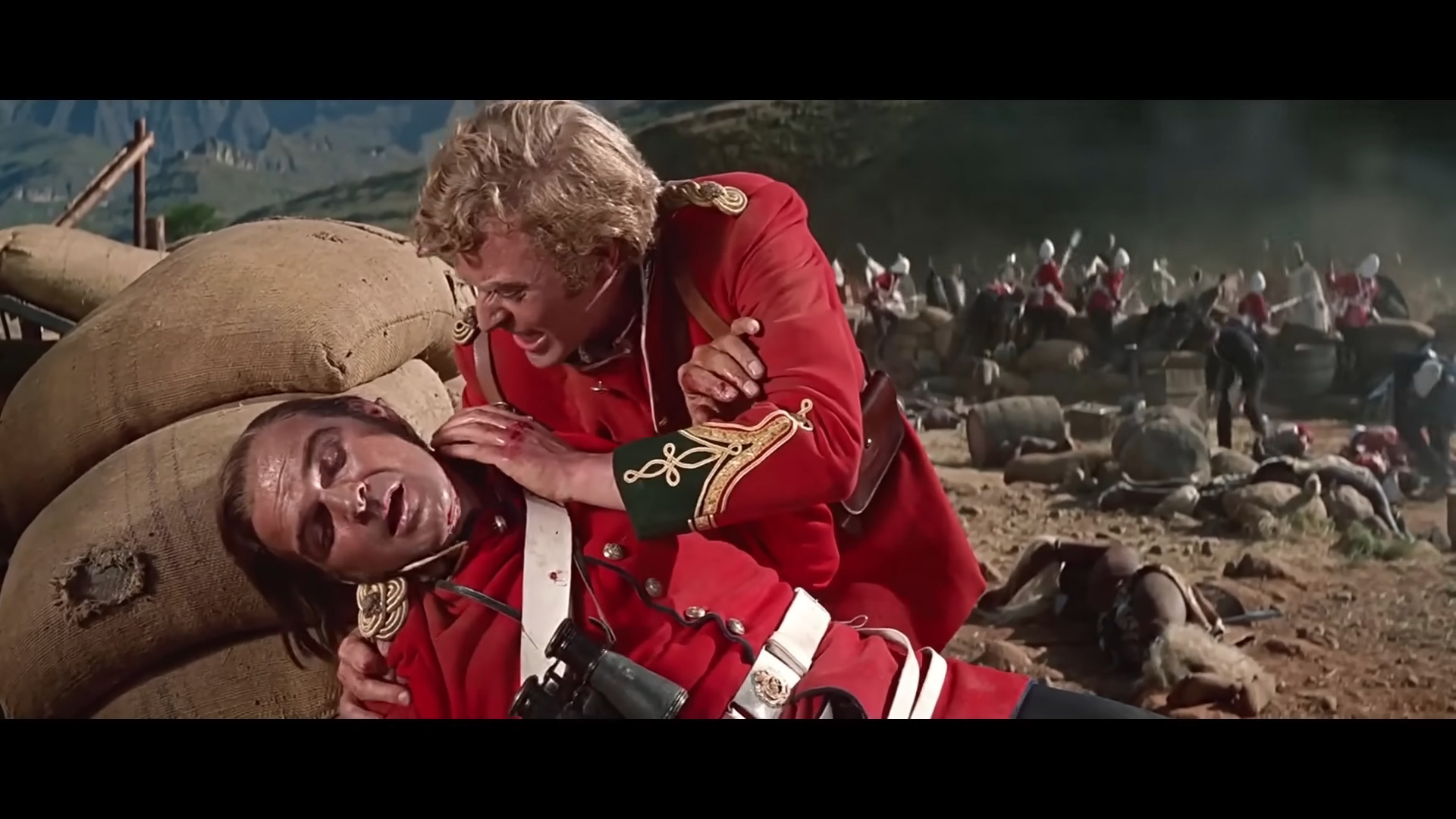 Lt. Gonville Bromhead (Michael Caine) checks on the wounded Lt. John Chard (Stanley Baker) in Zulu (1964), Diamond Films
