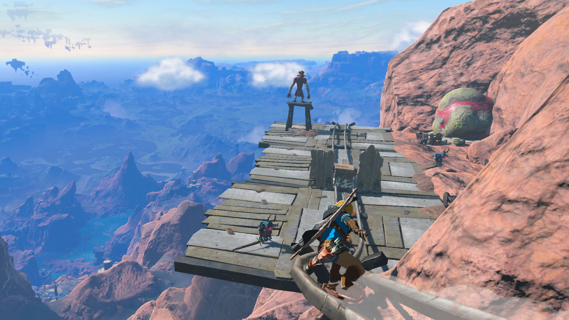 Link grinds on rails on a mountain, towards a wooden platform with Bokoblins and a Moblin via The Legend of Zelda: Tears of the Kingdom (2023), Nintendo