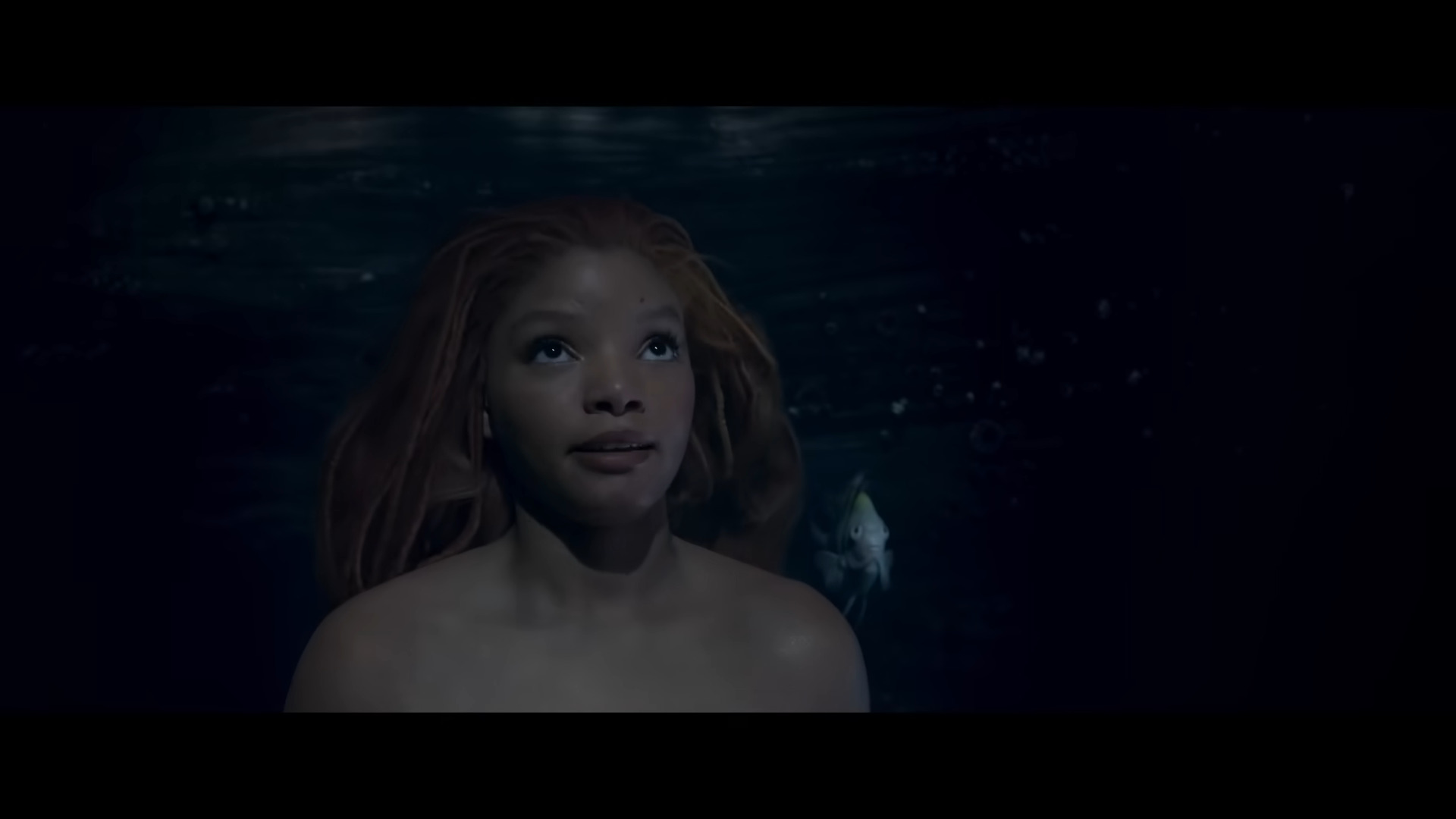 Ariel (Halle Bailey) explains herself to King Triton (Javier Bardem) in The Little Mermaid (2023), Disney