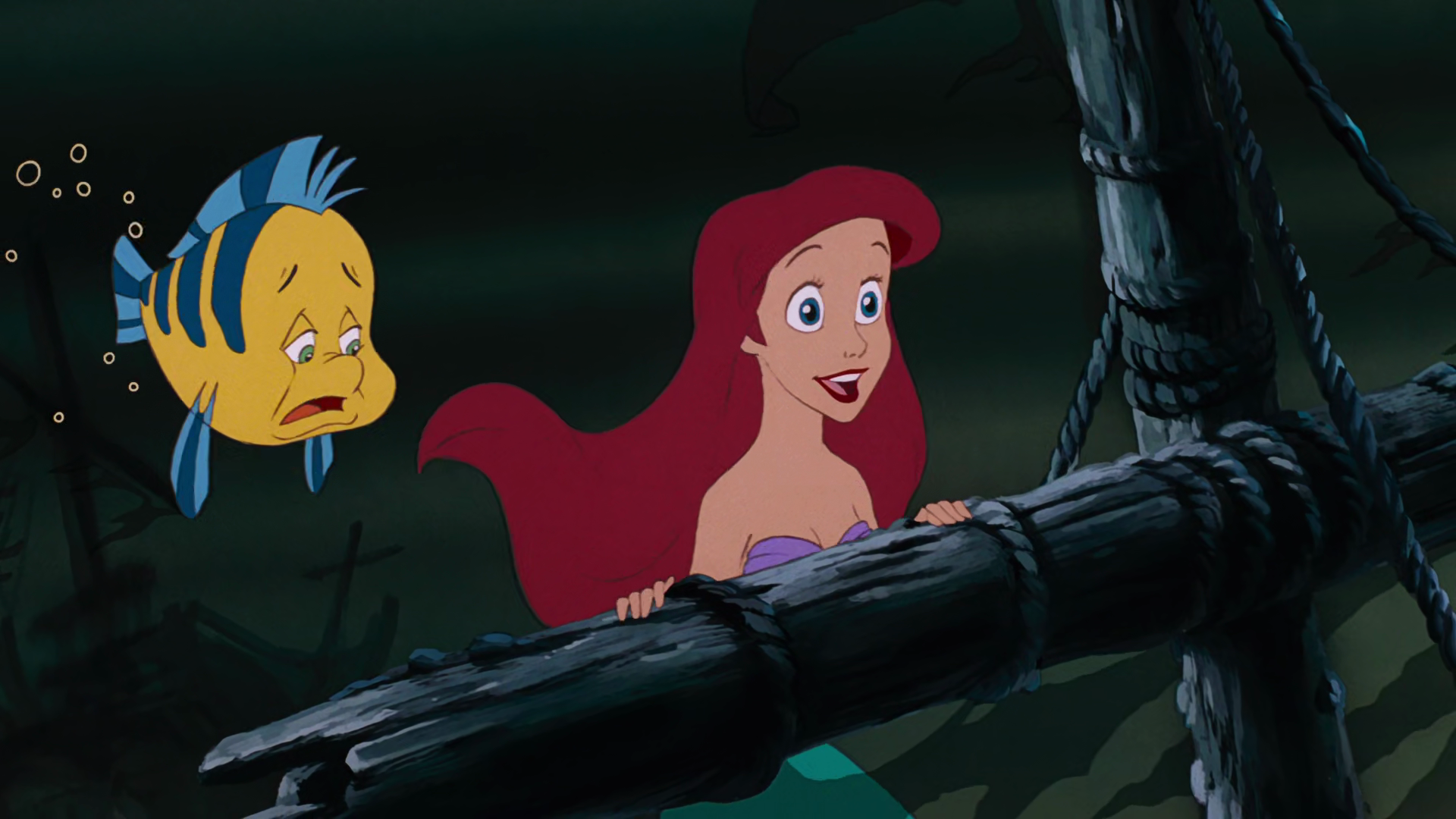 Ariel (Jodi Benson) drags a worried Flounder (Jason Marin) to explore a sunken ship in The Little Mermaid (1989), Disney