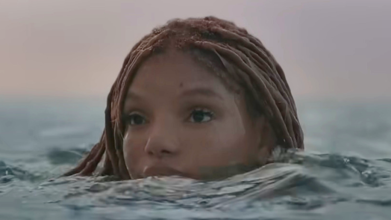 Ariel (Halle Bailey) pops her head above the ocean's surface in The Little Mermaid (2023), Disney