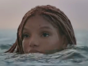 Ariel (Halle Bailey) pops her head above the ocean's surface in The Little Mermaid (2023), Disney