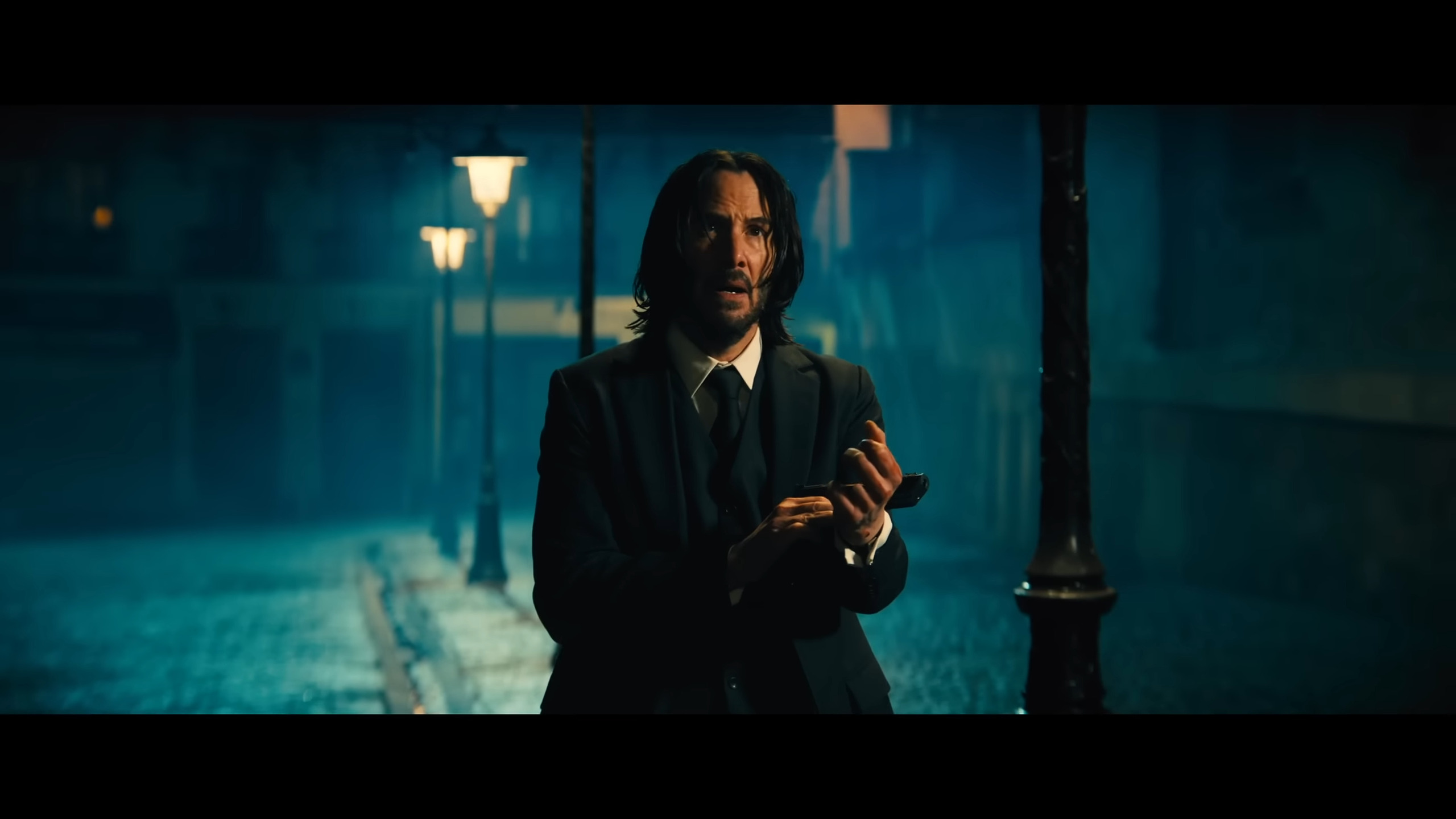 John Wick (Keanu Reeves) realizes time is running out in John Wick: Chapter 4 (2023), Lionsgate Films