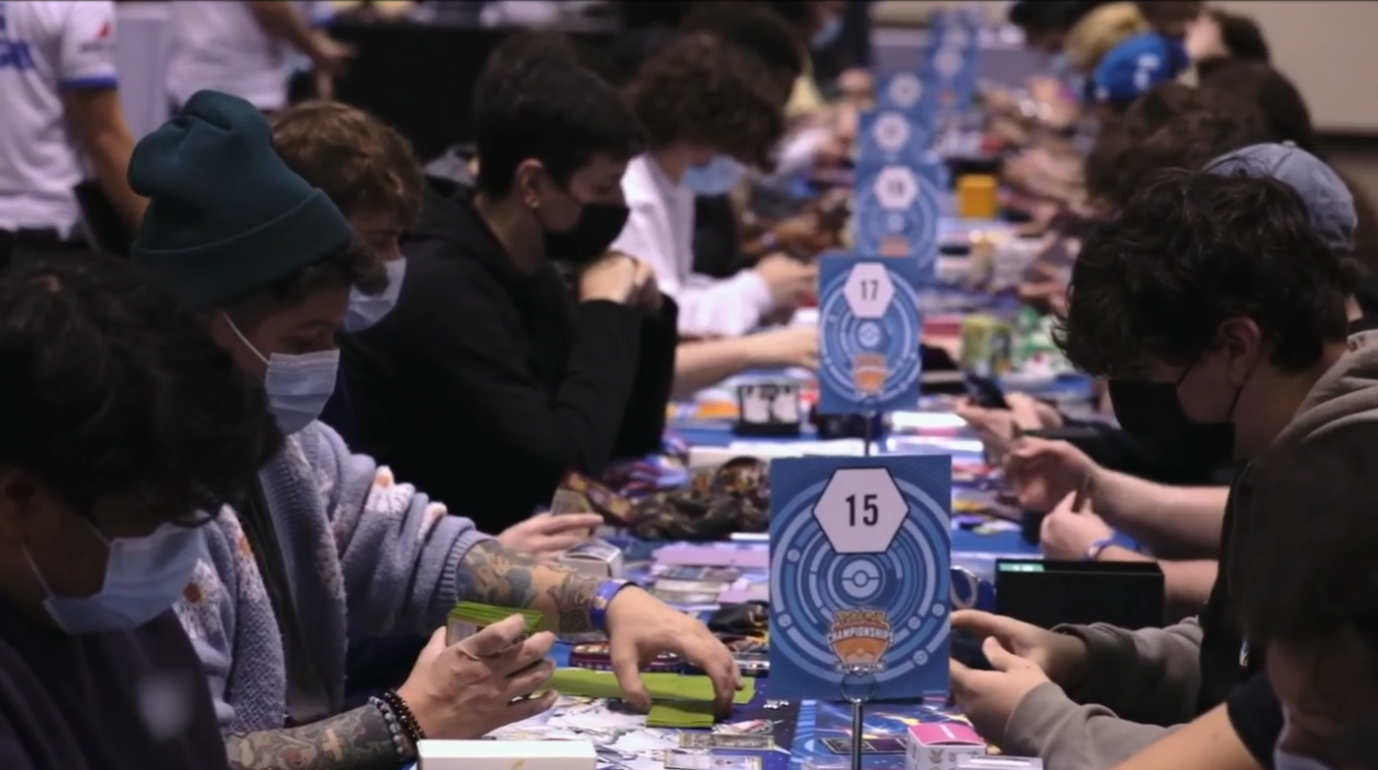 Multiple tables with players playing the Pokémon Trading Card Game wearing face masks via TCG Day 1 | 2023 Pokémon Charlotte Regional Championships, PokemonTCG Twitch
