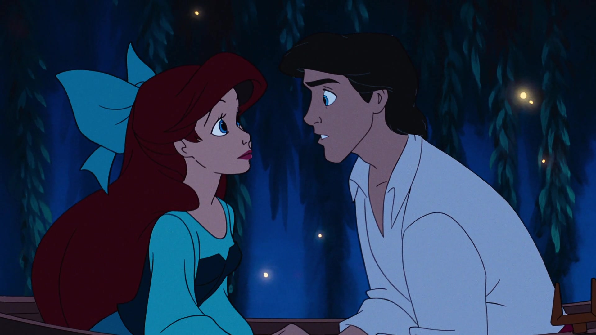 Ariel (Jodi Benson) and Prince Eric (Christopher Daniel Barnes) lean in to share their first kiss in The Little Mermaid (1989), Disney