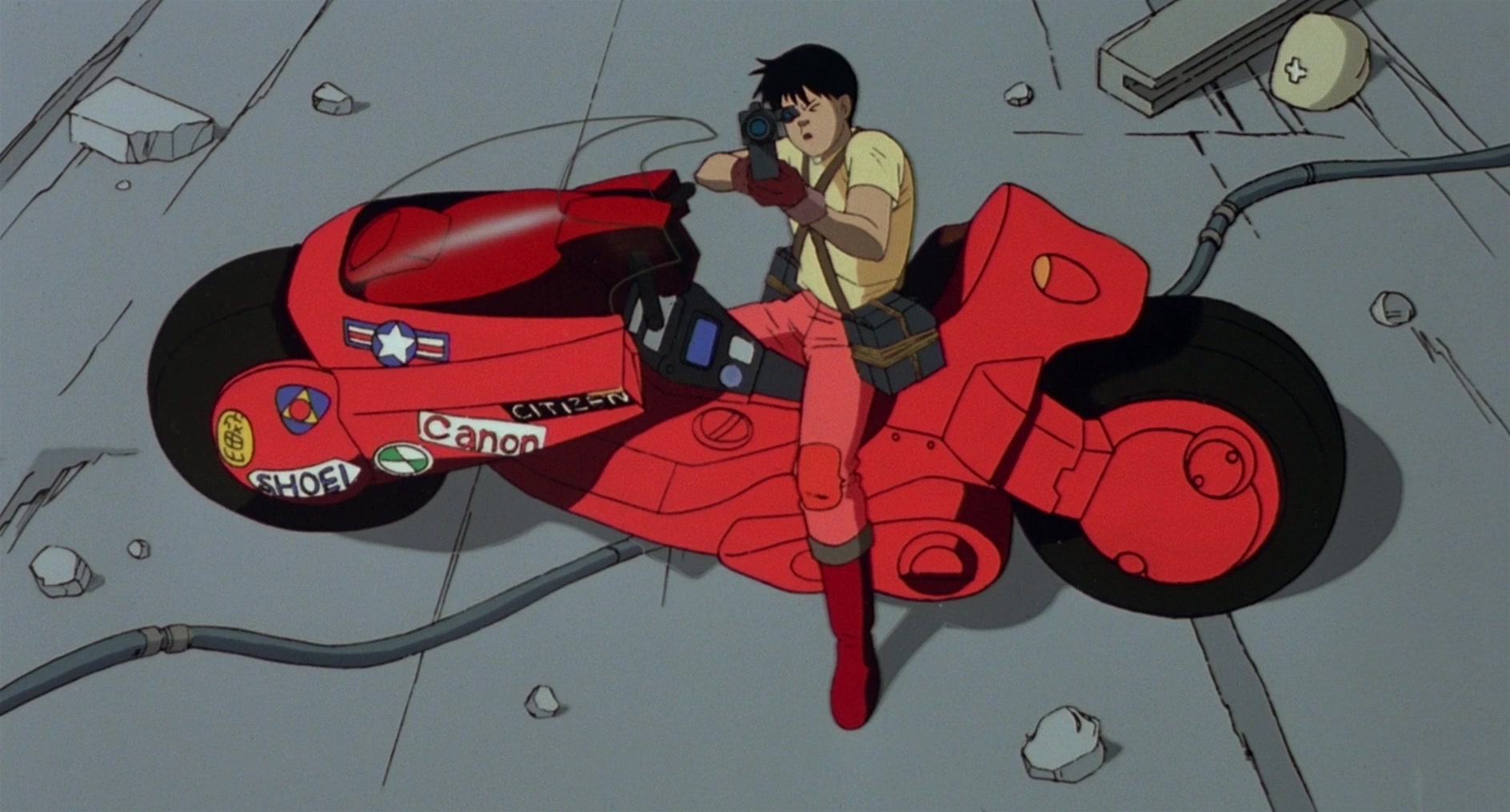 Kaneda (Mitsuo Iwata) takes aim at a mutating Tetsuo (Nozomu Sasaki) in Akira (1988), Toho Co. Ltd.