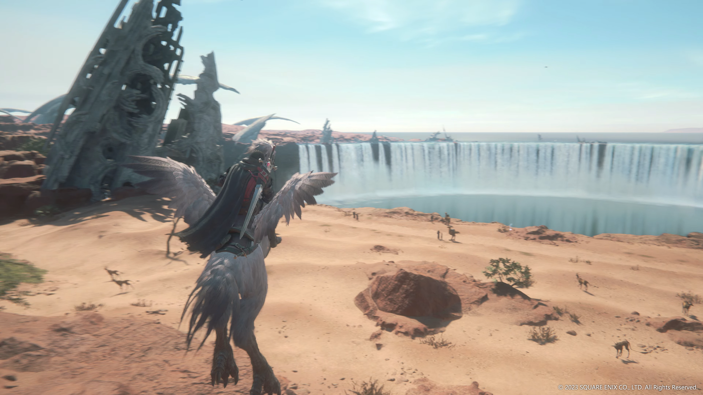 Clive Rosfield (Yuma Uchida) rides across the desert on a Chocobo, a large lake and waterfalls can be seen in the distance via Final Fantasy XVI (2023), Square Enix