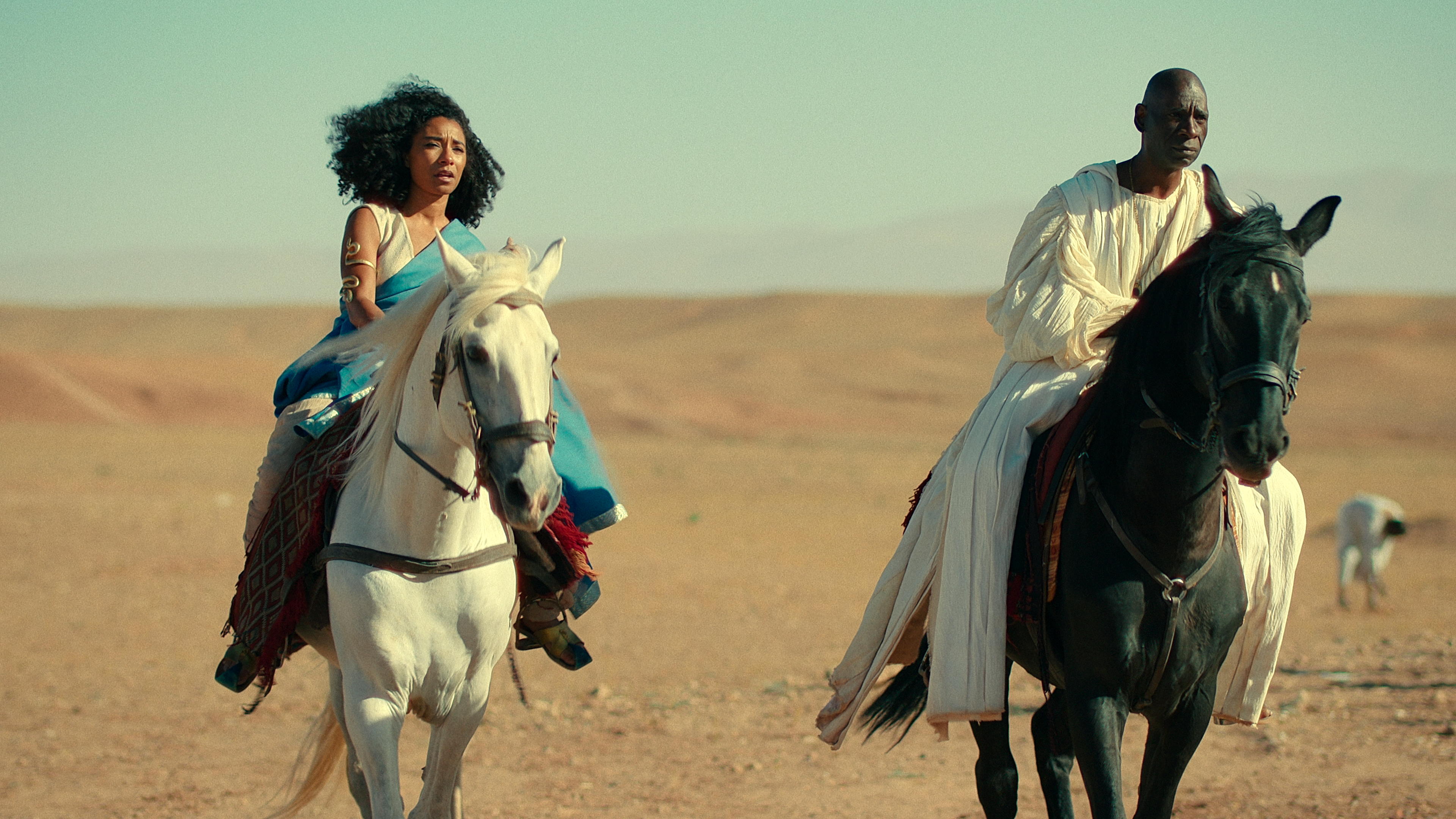 Cleopatra (Adele James) rides across the desert sands in Queen Cleopatra (2023), Netflix