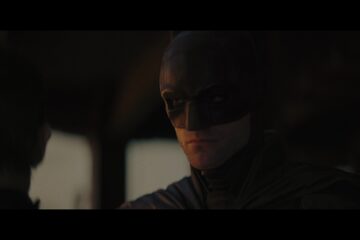 Bruce Wayne (Robert Pattinson) speaks with Selina Kyle (Zoë Kravitz) in The Batman (2022), Warner Bros. Pictures