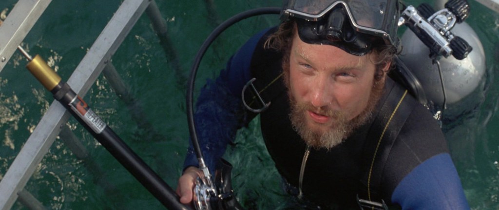Marine biologist Matt Hooper (Richard Dreyfuss) enters a shark-proof cage in a desperate measure to kill the vicious shark in Jaws (1975), Universal Pictures