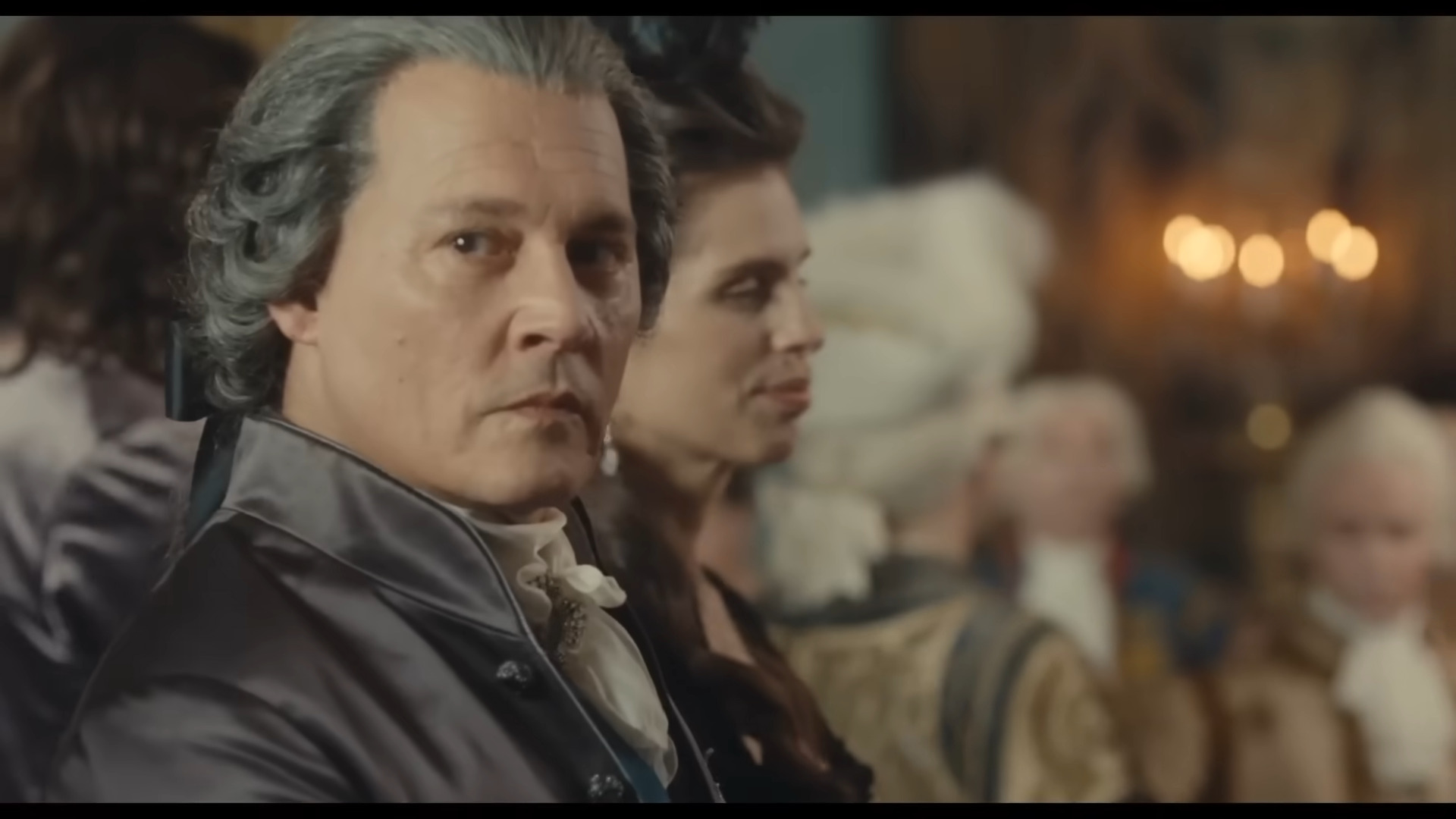 Louis XV (Johnny Depp) surveys the court in Jeanne du Barry (2023), La Pacte