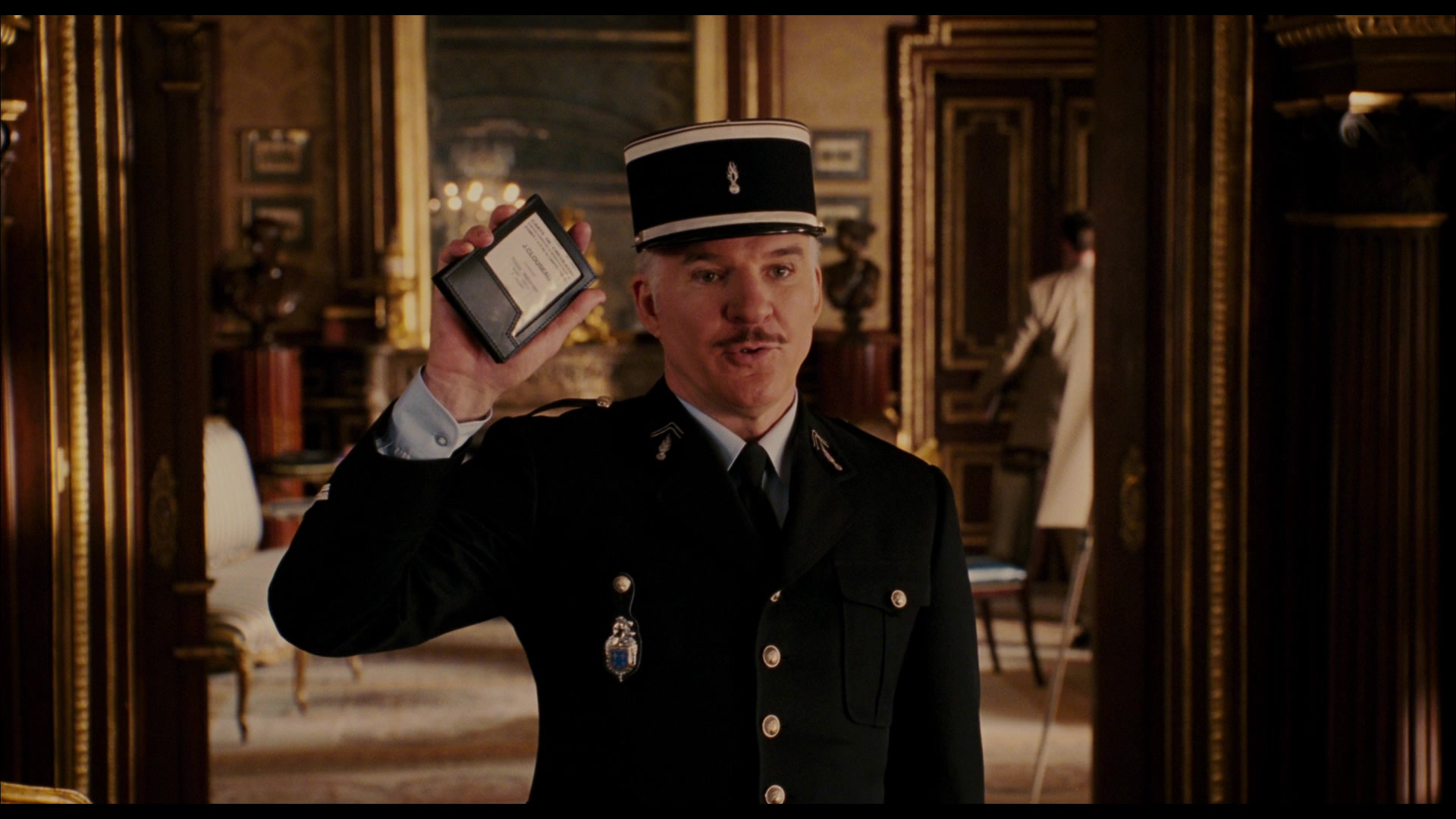 Inspector Clouseau (Steve Martin) shows his credentials in The Pink Panther (2006), MGM