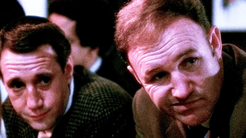 Jimmy "Popeye" Doyle (Gene Hackman) and Buddy "Cloudy" Russo (Roy Scheider) take in the scene at the Copacabana in The French Connection (1971), 20th Century Studios