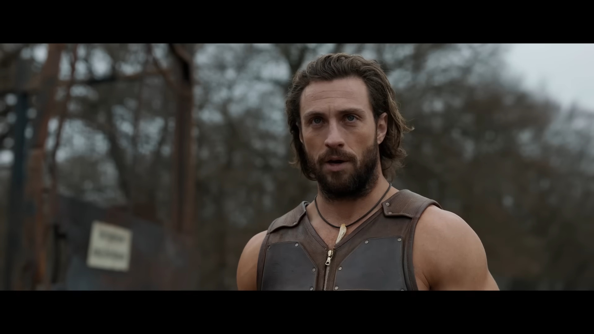 Kraven (Aaron Taylor-Johnson) taunts a group of poachers in Kraven the Hunter (2023), Sony Pictures