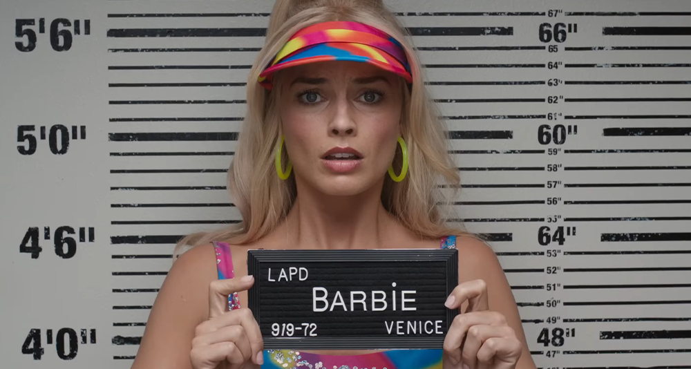 Barbie (Margot Robbie) is arrested in Los Angeles n in Barbie (2023), Warner Bros. Pictures